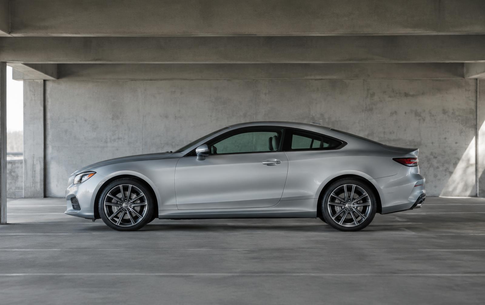 Side profile of a silver coupe in a concrete parking structure